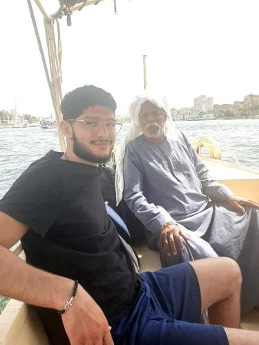 a man and a woman sitting on a boat at Rayan Nubian Guest House in Aswan