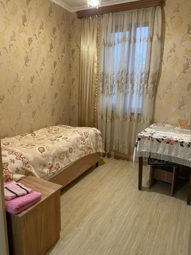 a bedroom with two beds and a window at Rubina Bed and Breakfast in Tatʼev