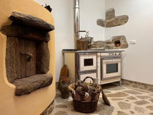 a kitchen with an old stove and a basket at Quinta da Mata de Baixo in Dornes