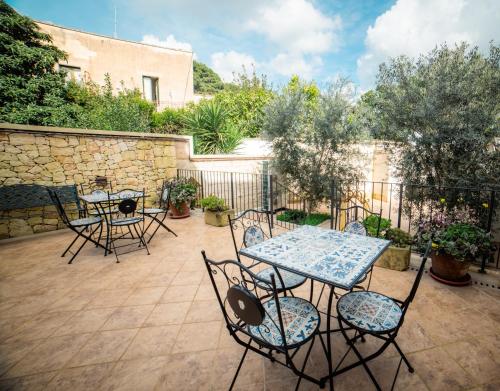 a patio with a table and chairs and a fence at Dimora Carafa apartment in Lecce