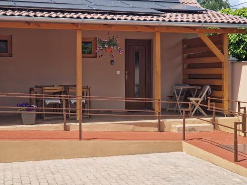 a porch of a house with a table and chairs at Polár in Makó