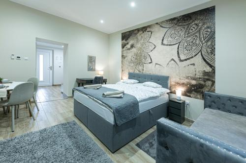 a bedroom with a large bed and a dining room at Polár in Makó