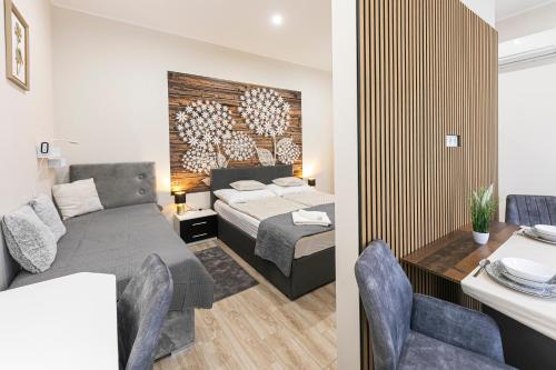 a bedroom with a bed and a desk in a room at Polár in Makó