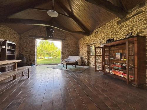 a large living room with a large window and a table at Aux 12 instants, Imagine in Lédergues