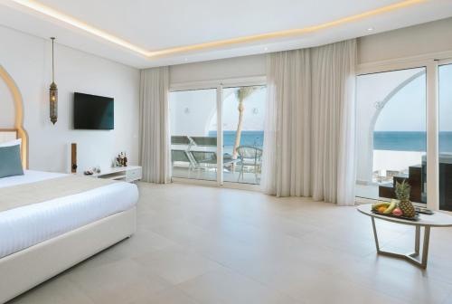 a bedroom with a bed and a view of the ocean at Sunrise Remal Beach Resort in Sharm El Sheikh