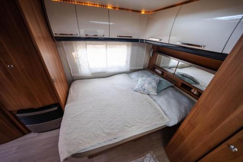 a small bed in the middle of a small room at Beach Garden Brač in Mirce