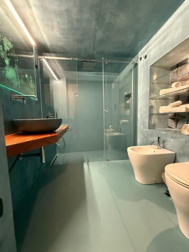 a bathroom with a shower and a sink and a toilet at Il cortile di Elen in Marsala