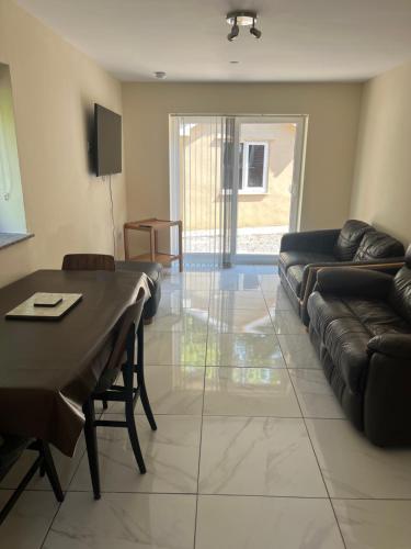 a living room with a table and a couch at Castell Cottages Central with Parking in Caerphilly