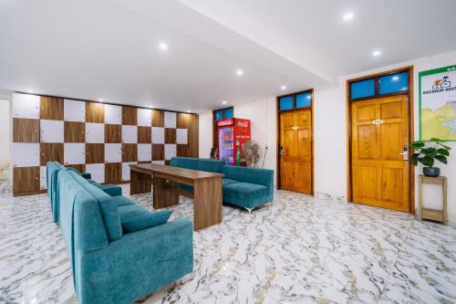 a waiting room with two blue chairs and a table at Ha Giang Rabbit Hostel & Tours in Ha Giang