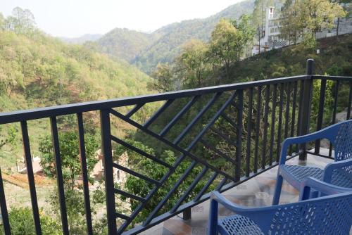 a balcony with two chairs and a table with a view at Cloud Forest in Lansdowne