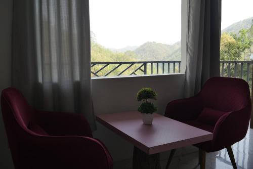 a room with two chairs and a table and a window at Cloud Forest in Lansdowne