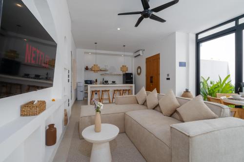a living room with a couch and a table at Casa Agapi in Tumbak Bayuh