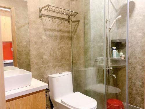 a bathroom with a shower and a toilet and a sink at The Sun Avenue Serviced Apartment in Ho Chi Minh City