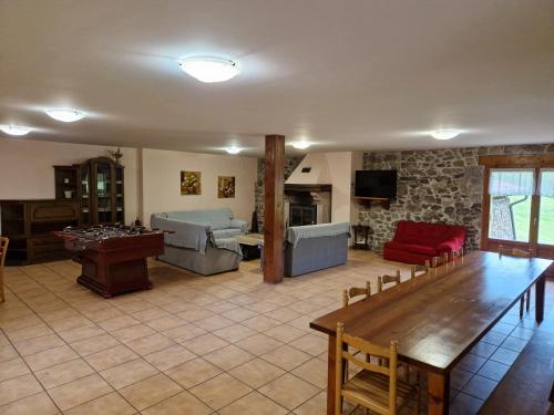 a large living room with a table and a couch at Casa Rural Zimitxu in Etxalar