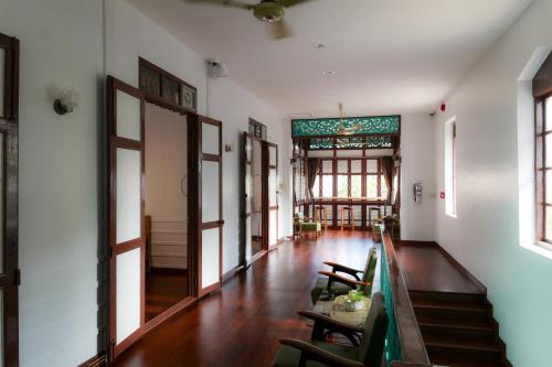 a hallway with tables and chairs in a building at Au samlor guesthouse in Chinatown