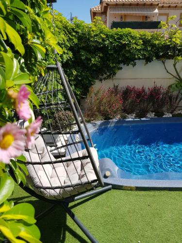 a basket sitting next to a swimming pool at Villa La Zenia, Private pool, 10min walk to La Zenia Beach, for 6 people in Playas de Orihuela