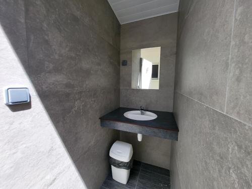 a bathroom with a sink and a mirror at Camping La Charderie in Pont-de-Labeaume
