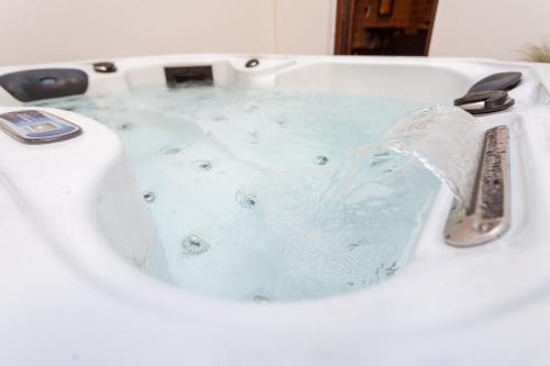 a bath tub with water pouring out of a faucet at Utopia Luxury Suites - Old Town in Rhodes Town