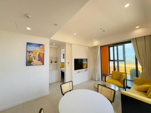 a living room with a couch and a table at Sunset town Phú Quốc in Phu Quoc