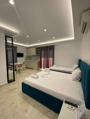 a bedroom with a large bed and a living room at Relax Apartments SB in Himare