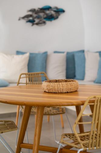 a wooden table with chairs and pillows in a room at Messavόli Residences in Mesaria