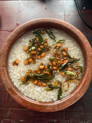 a bowl of soup with beans and greens in it at Captain's Castle in Pallipuram