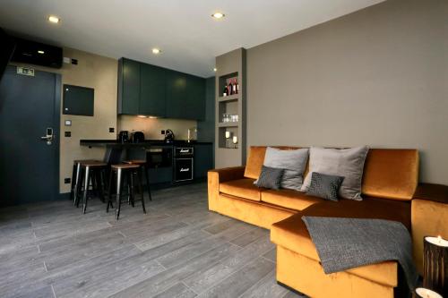a living room with a couch and a kitchen at Charm Flats in Lisbon