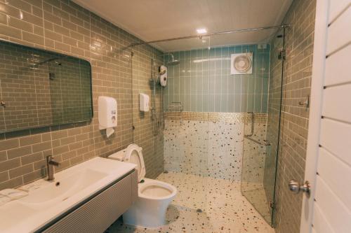 a bathroom with a toilet and a sink and a shower at Khaoyai Art Tree in Pong Talong