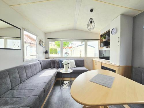 a living room with a couch and a table at Hollender Pool & Chill House Sarbinowo in Sarbinowo