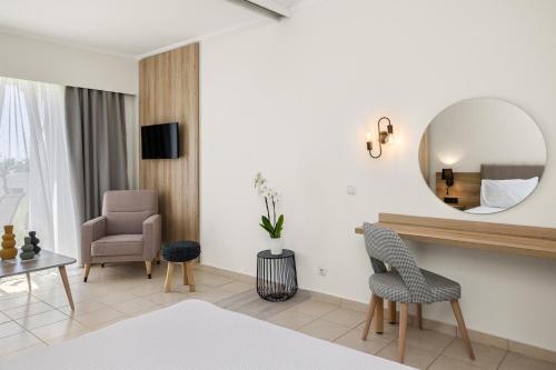 a living room with a mirror and a table and chairs at Kiotari Bay in Kiotari