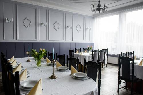 a dining room with a long table and chairs at Zajazd Saga in Gryfino