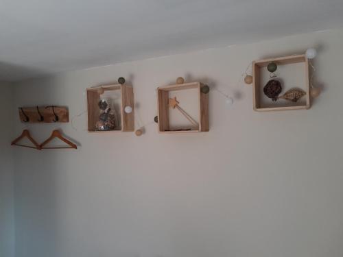 a group of clocks on a white wall at La halte verte in Nassogne