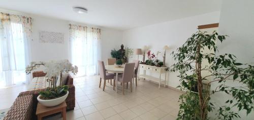 a living room with a table and a dining room at COSY HOME near DISNEYLAND PARIS in Serris