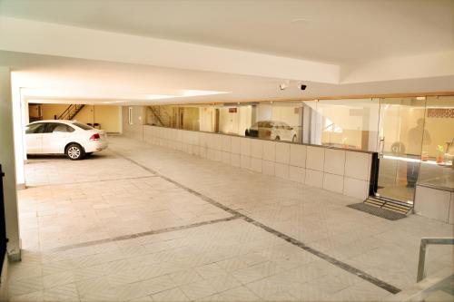 a parking lot with a car parked in a garage at Hotel Le Palace in Coimbatore