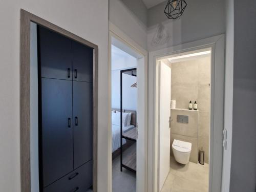 a bathroom with a toilet and a bathroom with a shower at Aelia Blu 1 in Ofrínion