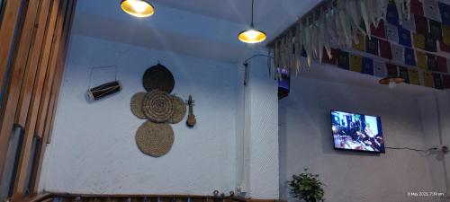 a wall with a wooden object on a wall at A&A Apartment in Namchi