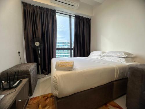 a bedroom with a large white bed with a window at BORNEO Sutera Bay in Kota Kinabalu