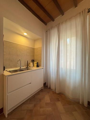 a kitchen with a sink and a window at Casa Arte in San Quirico dʼOrcia
