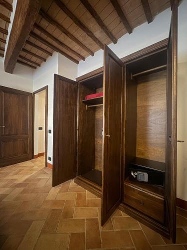 a living room with wooden cabinets and a tv at Casa Arte in San Quirico dʼOrcia