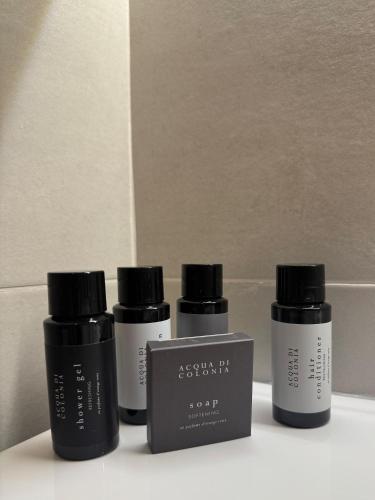a group of three products sitting on a shelf at Casa Arte in San Quirico dʼOrcia