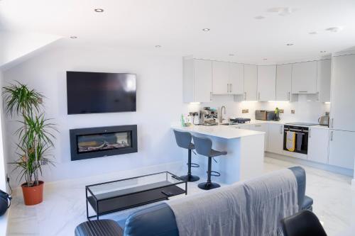 a living room with a couch and a fireplace at The Open 2025 Accommodation in Ballycastle