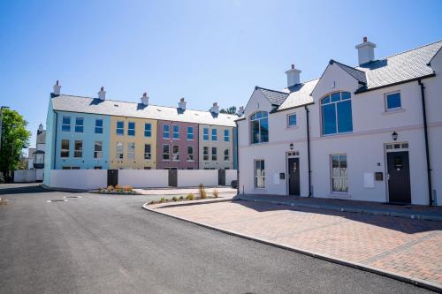 a row of buildings on the side of a street at The Open 2025 Accommodation in Ballycastle