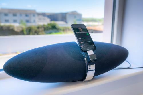 a black pillow with a remote control sitting on a window sill at The Open 2025 Accommodation in Ballycastle