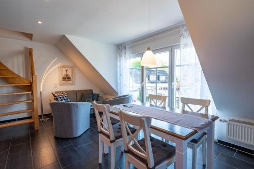 a dining room with a table and chairs at Arielle in Norddeich