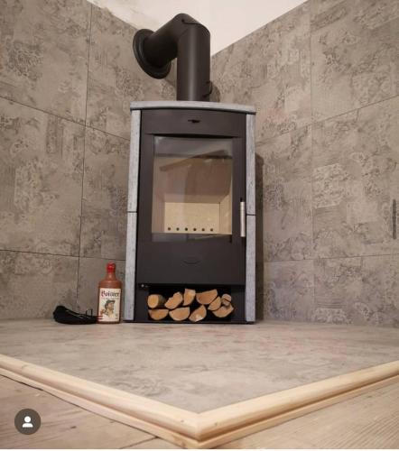 a wood fired oven with a pile of logs at Binter Haus -Rattendorf in Rattendorf
