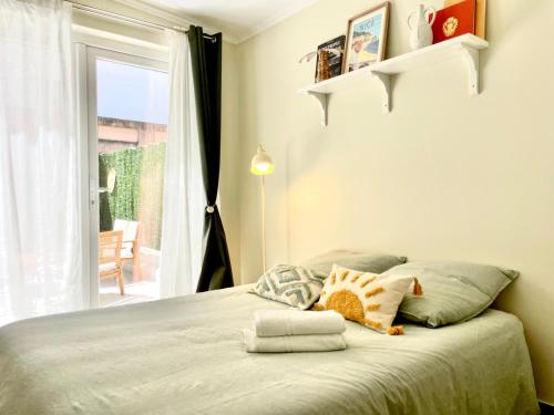 une chambre avec un lit avec des oreillers et une fenêtre dans l'établissement Le Petit Nice, à Nice