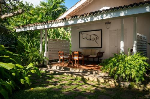 a patio with a table and chairs on a house at Nyne Hotels Rock Villa - Bentota in Bentota