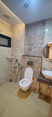 a bathroom with a toilet and a sink at Tanwar Hotel & Restro in Khandela