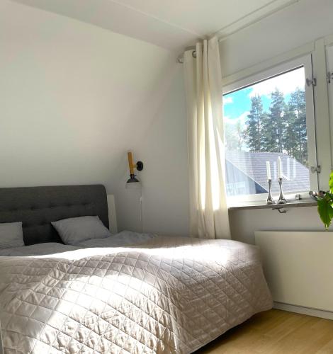 a bedroom with a bed and a window at Villa Åhus By The Beach in Åhus