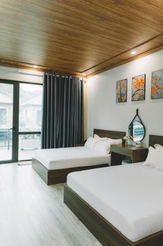 a hotel room with two beds and a window at Dragon Mountain Home in Ninh Binh - Center Of Heritage in Ninh Binh